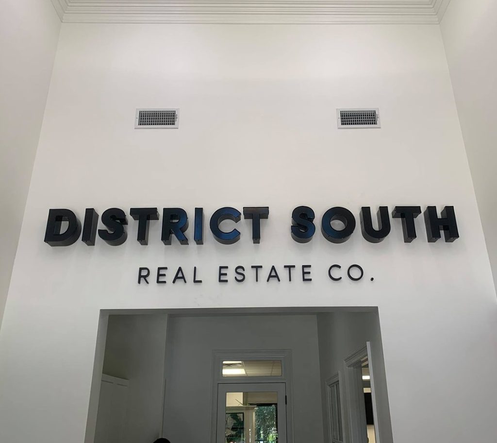 District South Real Estate signage above office door